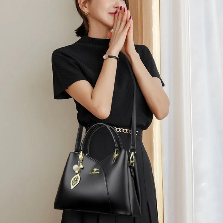 Elegant black shoulder bag with stylish charms
